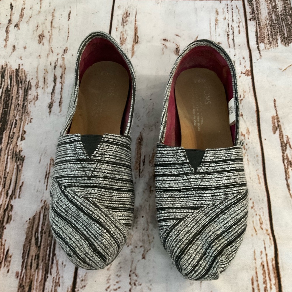 TOMS BLACK WHITE SILVER METALLIC SLIP ONS‎